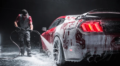 Velocity Auto Detailing website hero showing a performance car being professionally washed